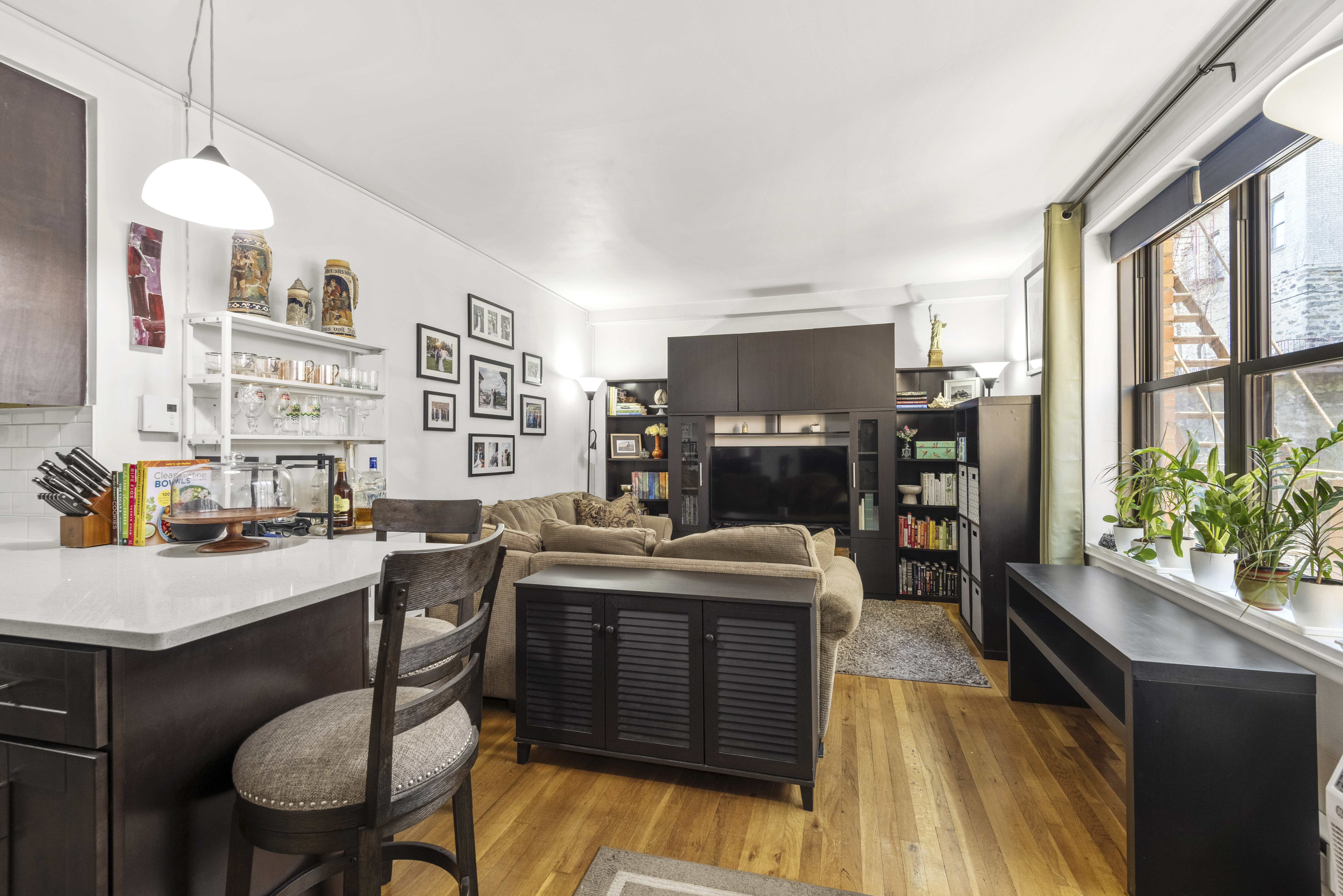 a room with stainless steel appliances kitchen island granite countertop furniture and a kitchen view