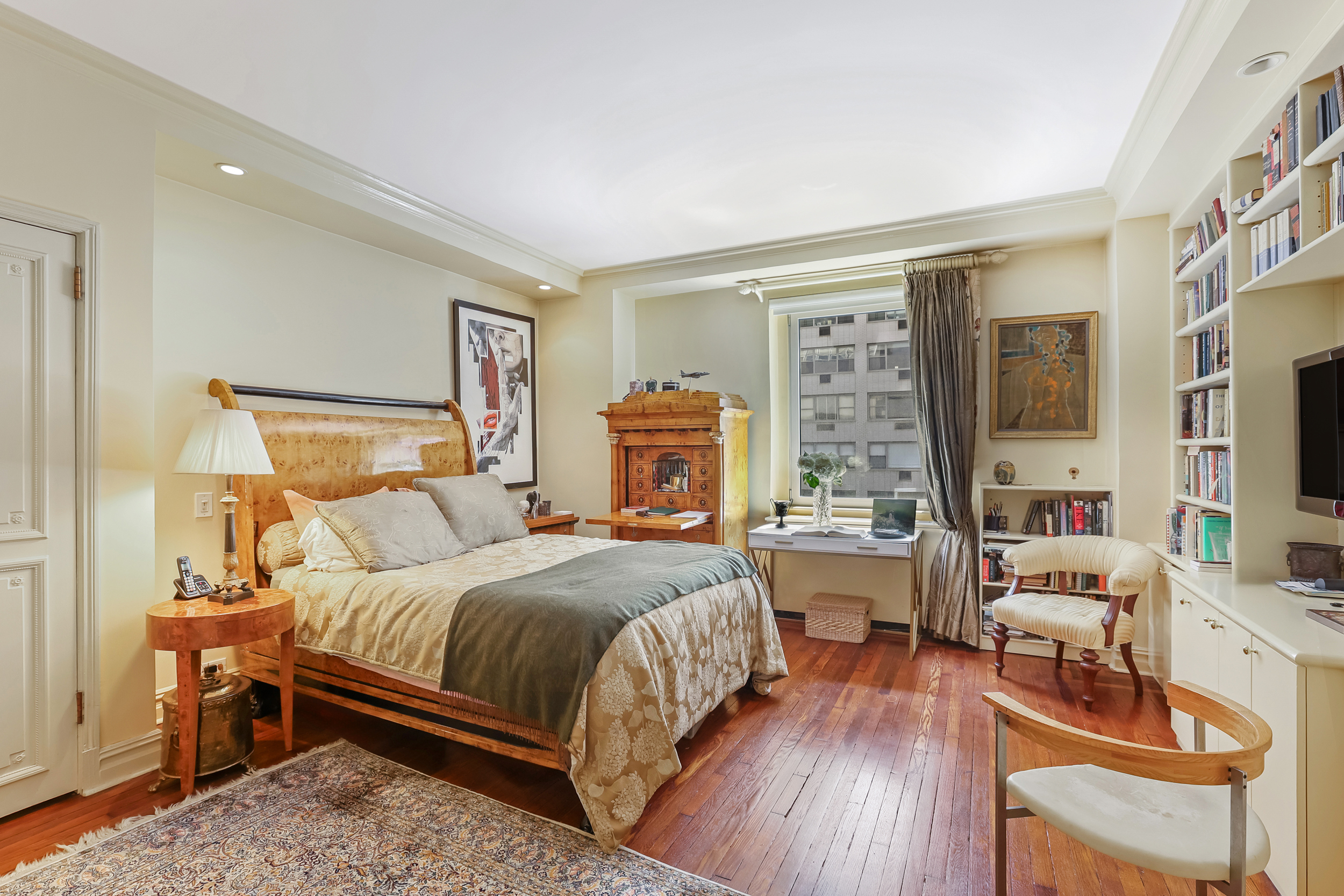 465 Park Avenue, Unit 409 Manhattan, NY 10022 - Photo 3 of 11 a bedroom with a bed and wooden floor