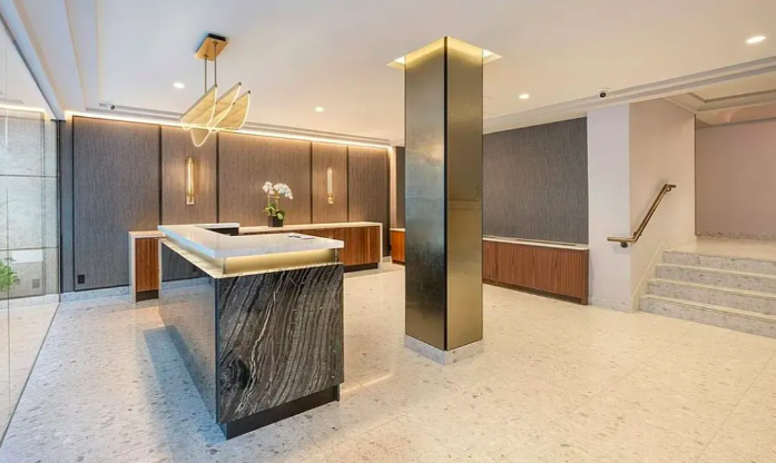 445 East 86th Street, Unit 6D Manhattan, NY 10028 - Photo 8 of 11 a kitchen with stainless steel appliances granite countertop a sink and a refrigerator