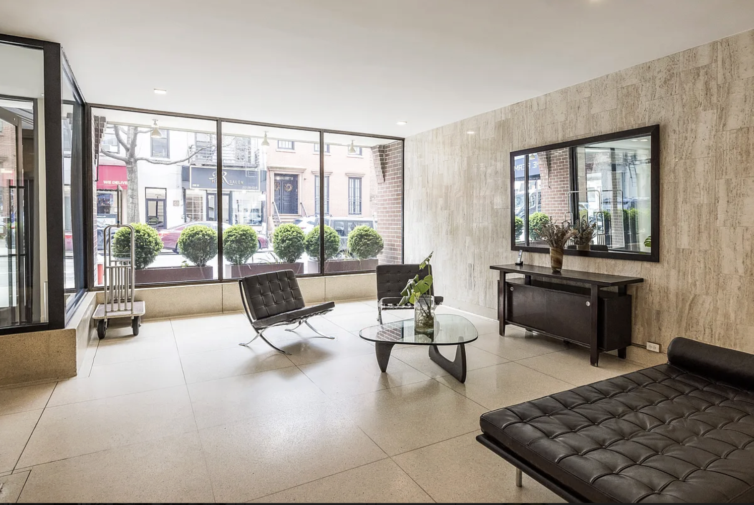 201 West 21st Street, Unit 5J Manhattan, NY 10011 - Photo 9 of 10 a living room with furniture and large windows