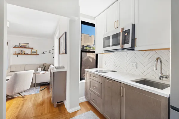 a kitchen with a sink and a refrigerator