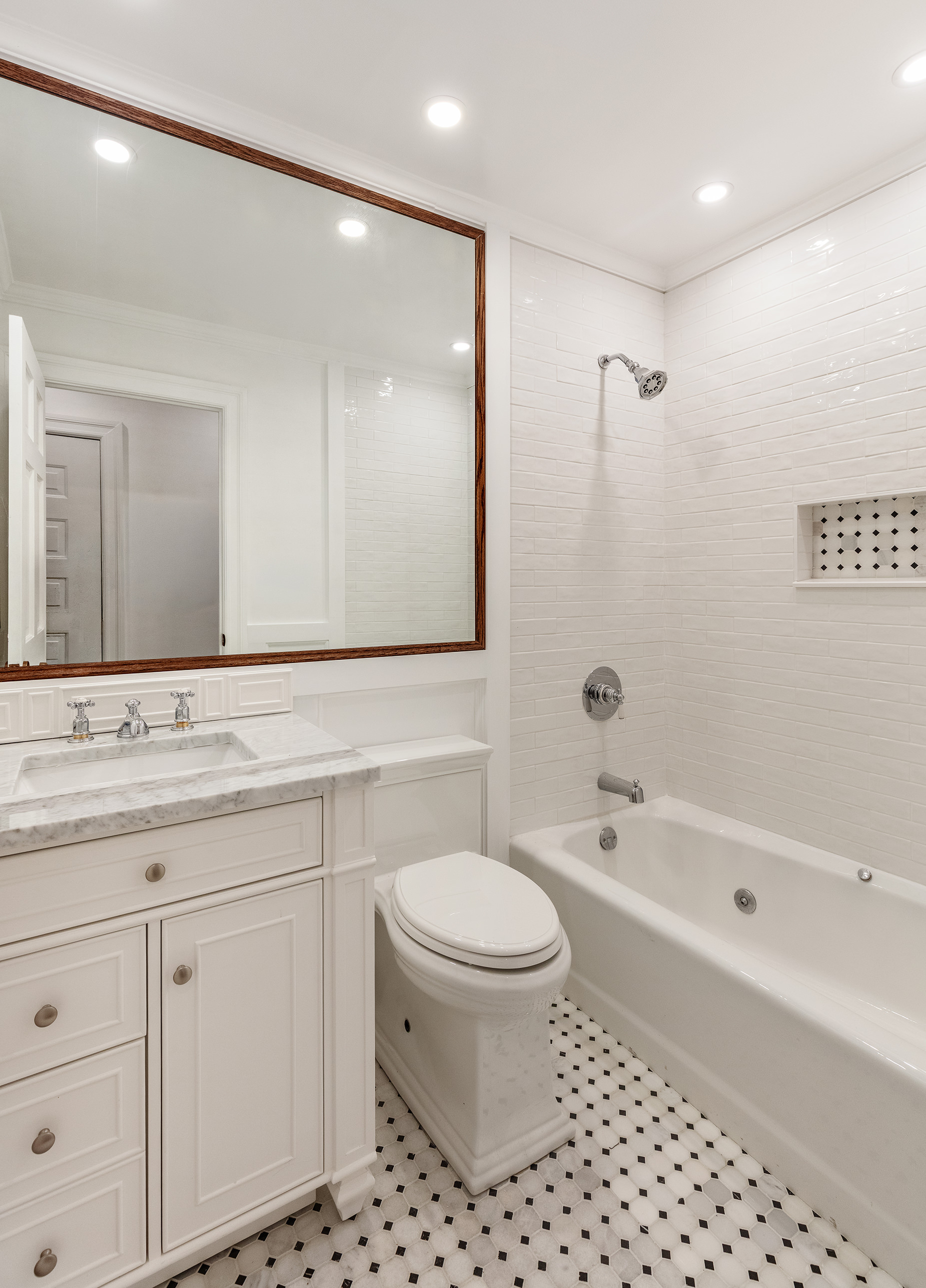 129 East 61st Street, Unit 3 Manhattan, NY 10065 - Photo 7 of 13 a bathroom with a bathtub shower sink vanity and toilet