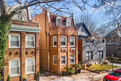 a front view of a residential apartment building with a yard