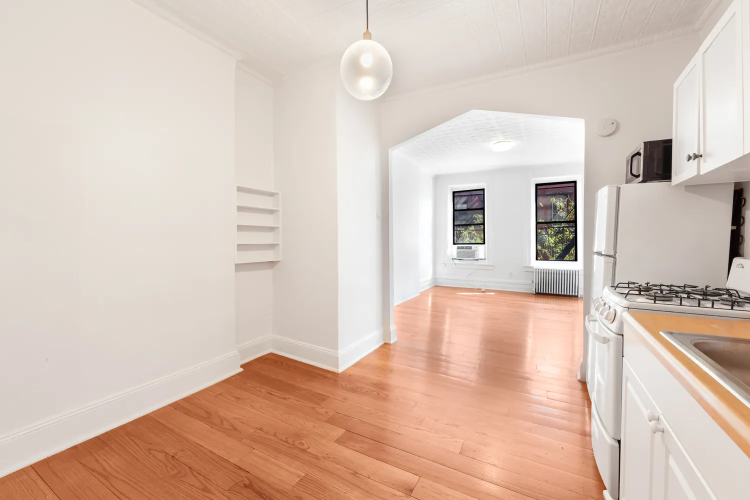 a view of a kitchen with wooden floor and a sink
