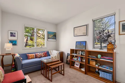 a reading room with furniture and a book shelf