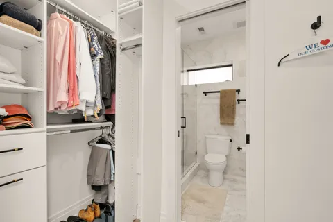 a bathroom with a shower sink vanity and a toilet