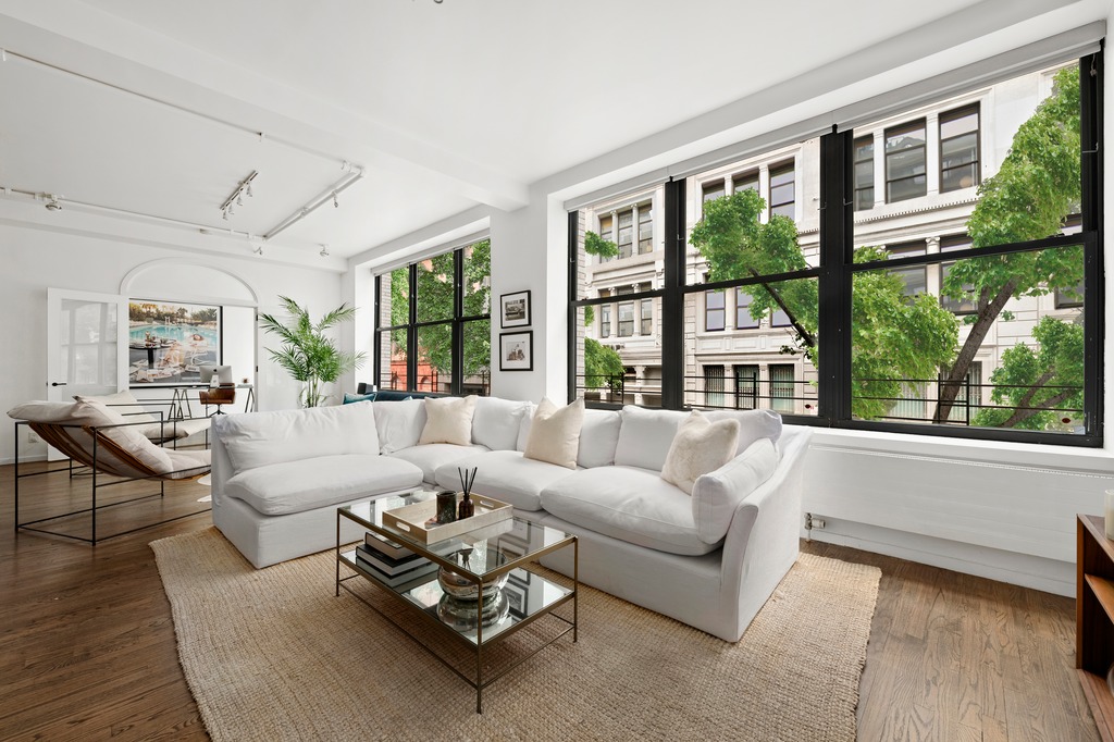 120 West 18th Street, Unit 2A Manhattan, NY 10011 - Photo 2 of 14 a living room with furniture and floor to ceiling windows