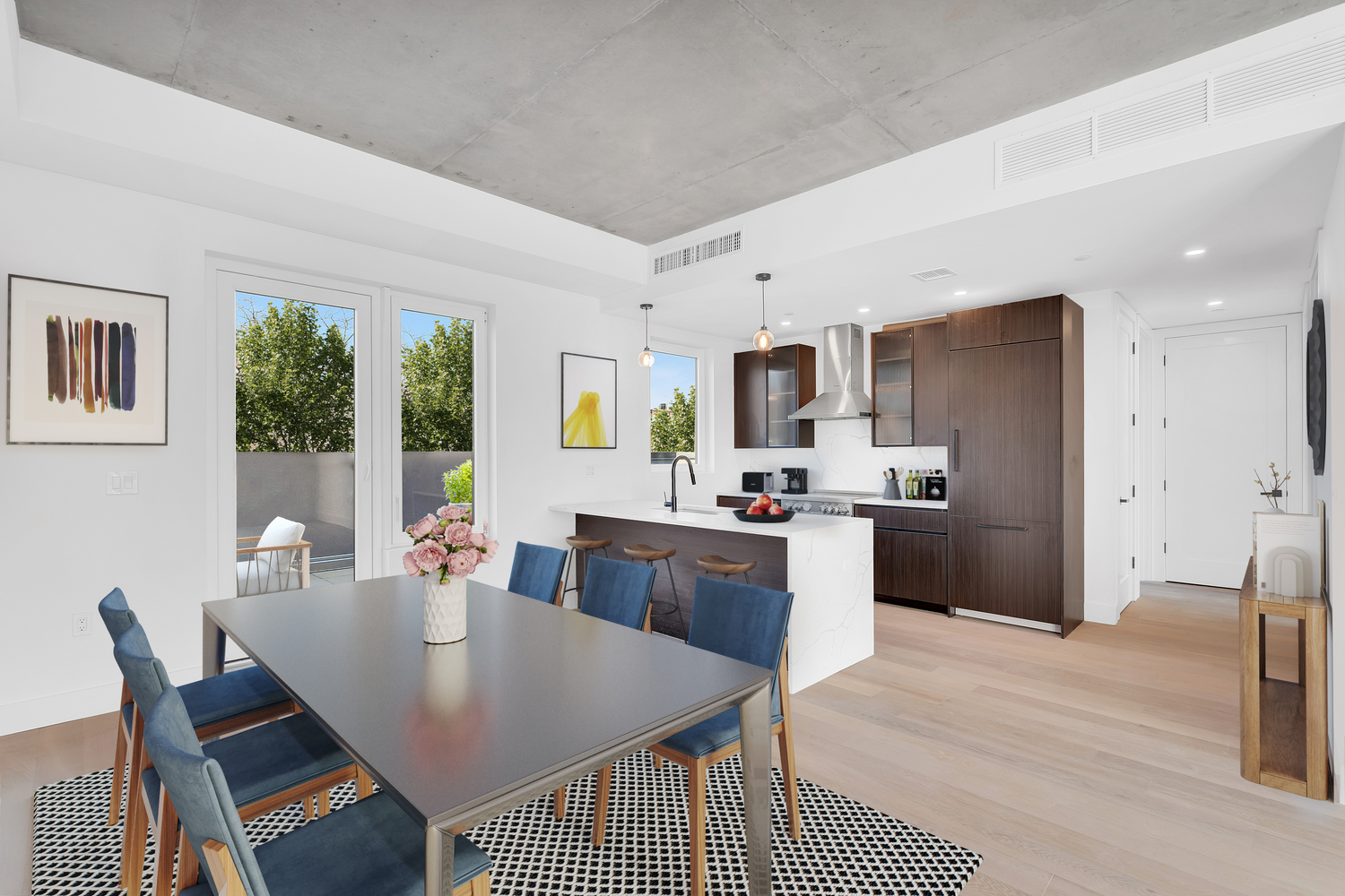 228 Vanderbilt Avenue, Unit 4A Brooklyn, NY 11205 - Photo 4 of 14 a kitchen with a table chairs refrigerator and microwave