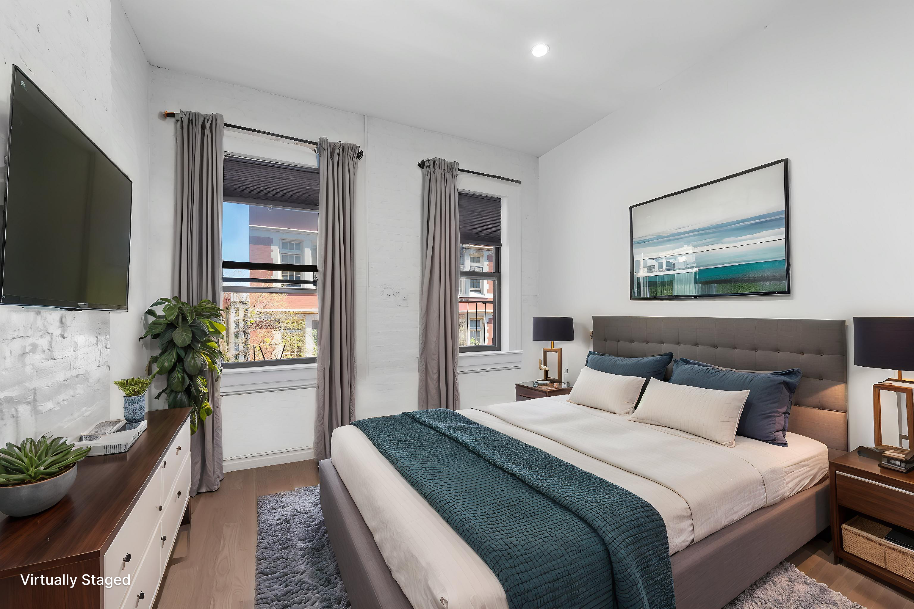 112 East 4th Street, Unit 4 Manhattan, NY 10003 - Photo 3 of 6 a bedroom with a large bed and a flat screen tv