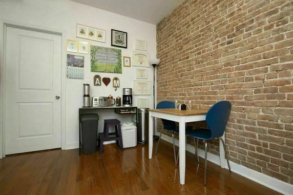a dining room with furniture and wooden floor