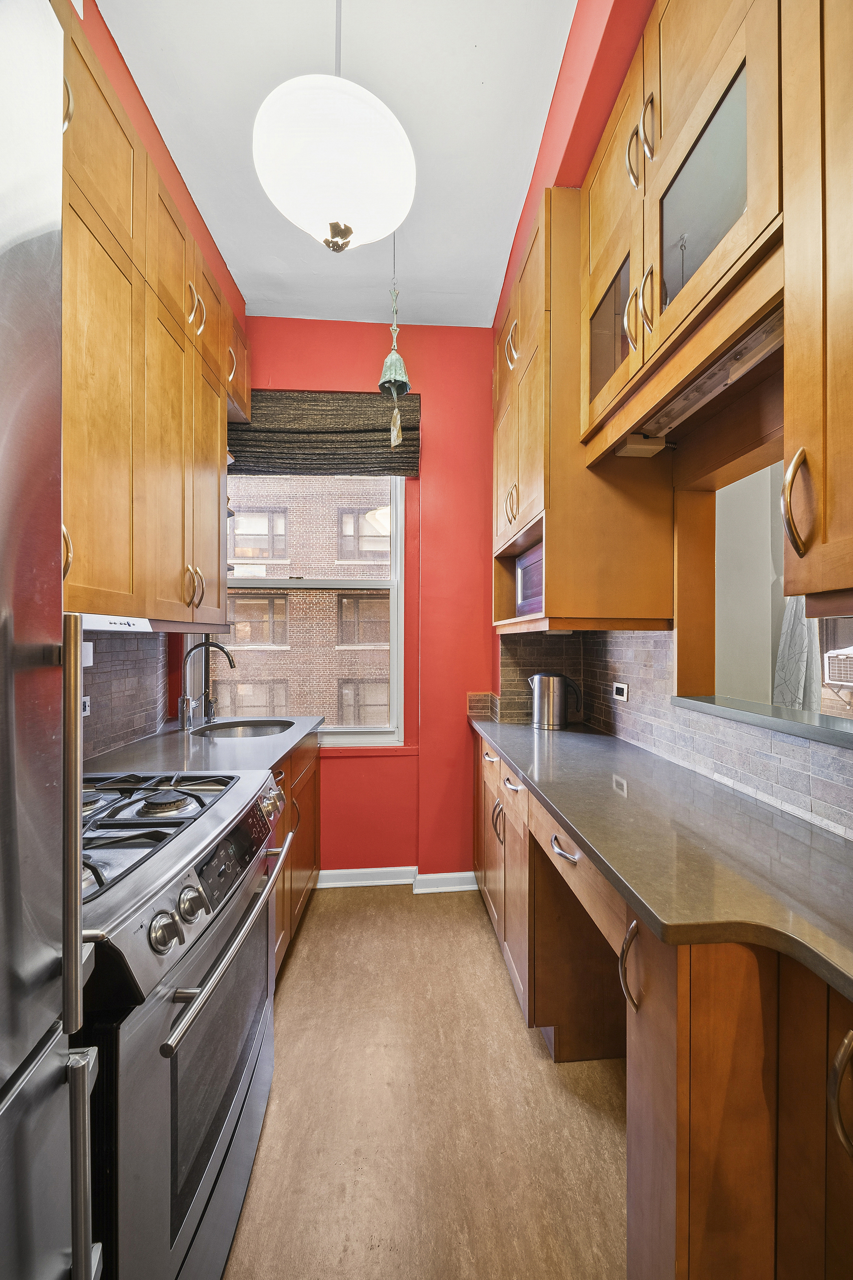 263 West End Avenue, Unit 9E Manhattan, NY 10023 - Photo 3 of 10 a kitchen with stainless steel appliances granite countertop a stove and a refrigerator