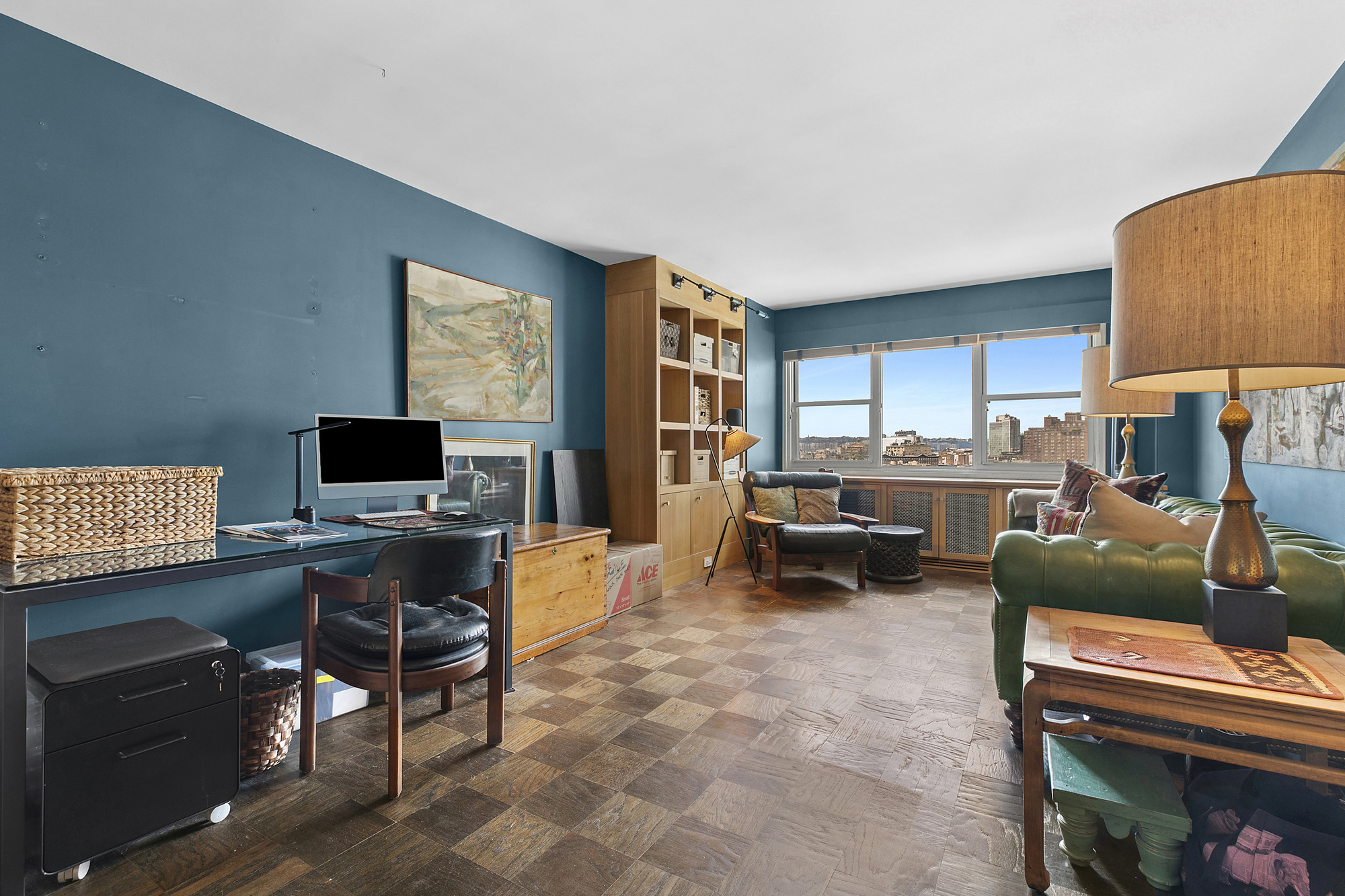 3 Sheridan Square, Unit 15A Manhattan, NY 10014 - Photo 4 of 11 a living room with furniture and a flat screen tv