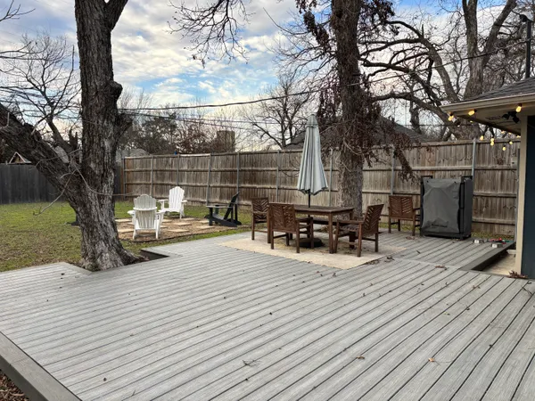 a view of a patio with table and chairs and wooden floor