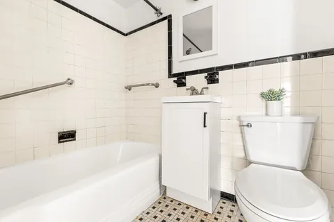 a white toilet sitting next to a bathroom sink