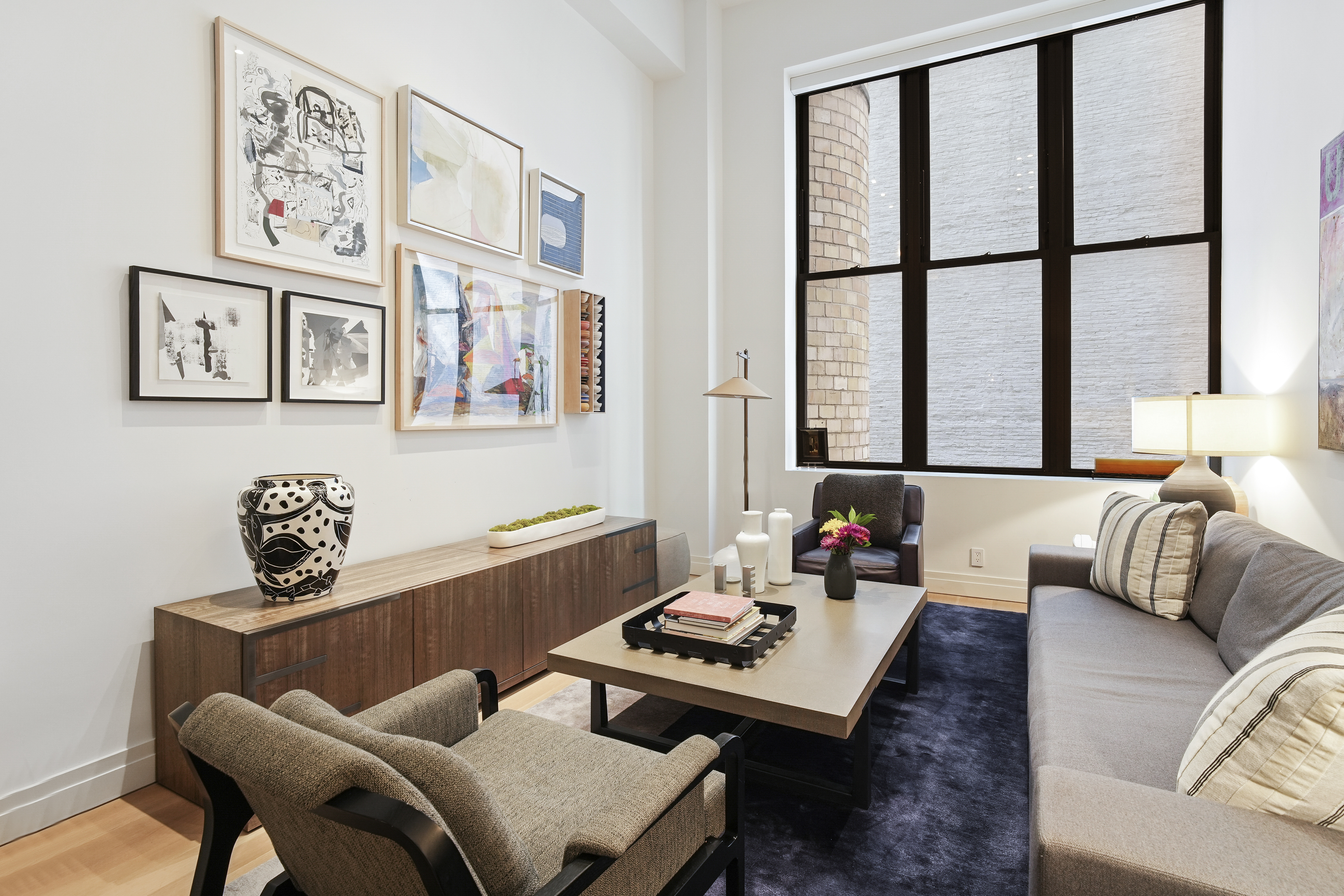 421 Hudson Street, Unit 221 Manhattan, NY 10014 - Photo 7 of 21 a living room with furniture and a large window