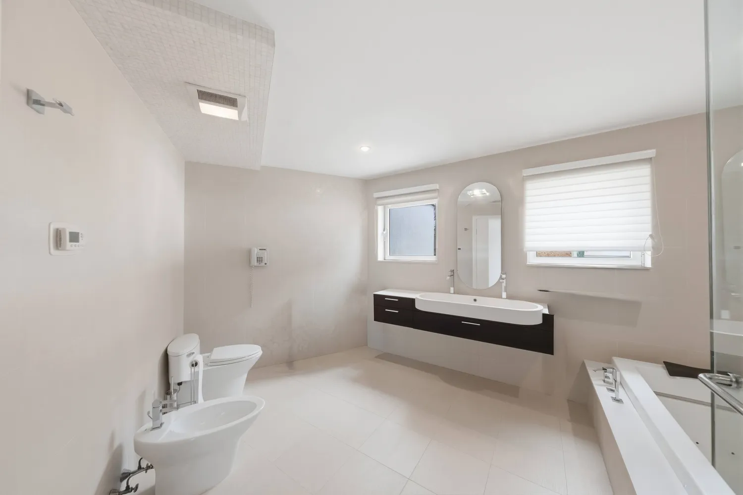 a spacious bathroom with a bathtub sink and toilet