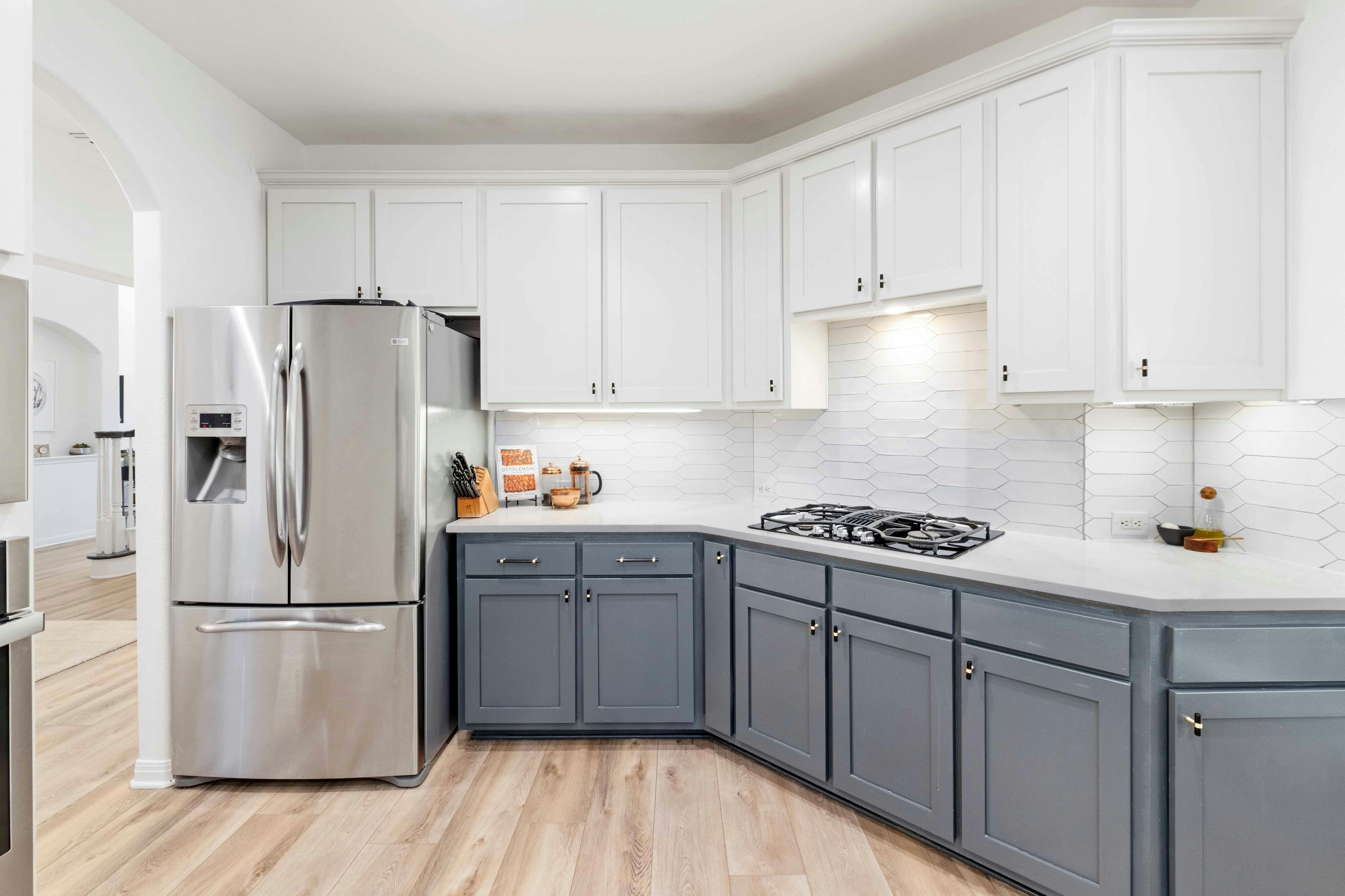 10608 Pointe View Drive Austin, TX 78738 - Photo 14 of 46 a kitchen with a refrigerator sink and cabinets