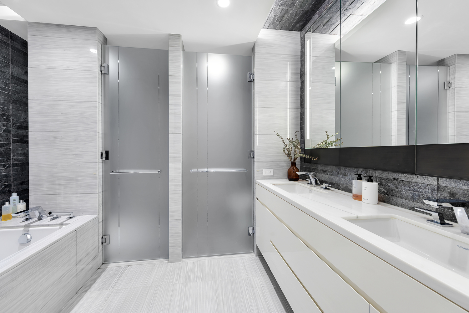 70 Charlton Street, Unit 3F Manhattan, NY 10014 - Photo 6 of 15 a bathroom with a sink double vanity granite tub shower and mirror