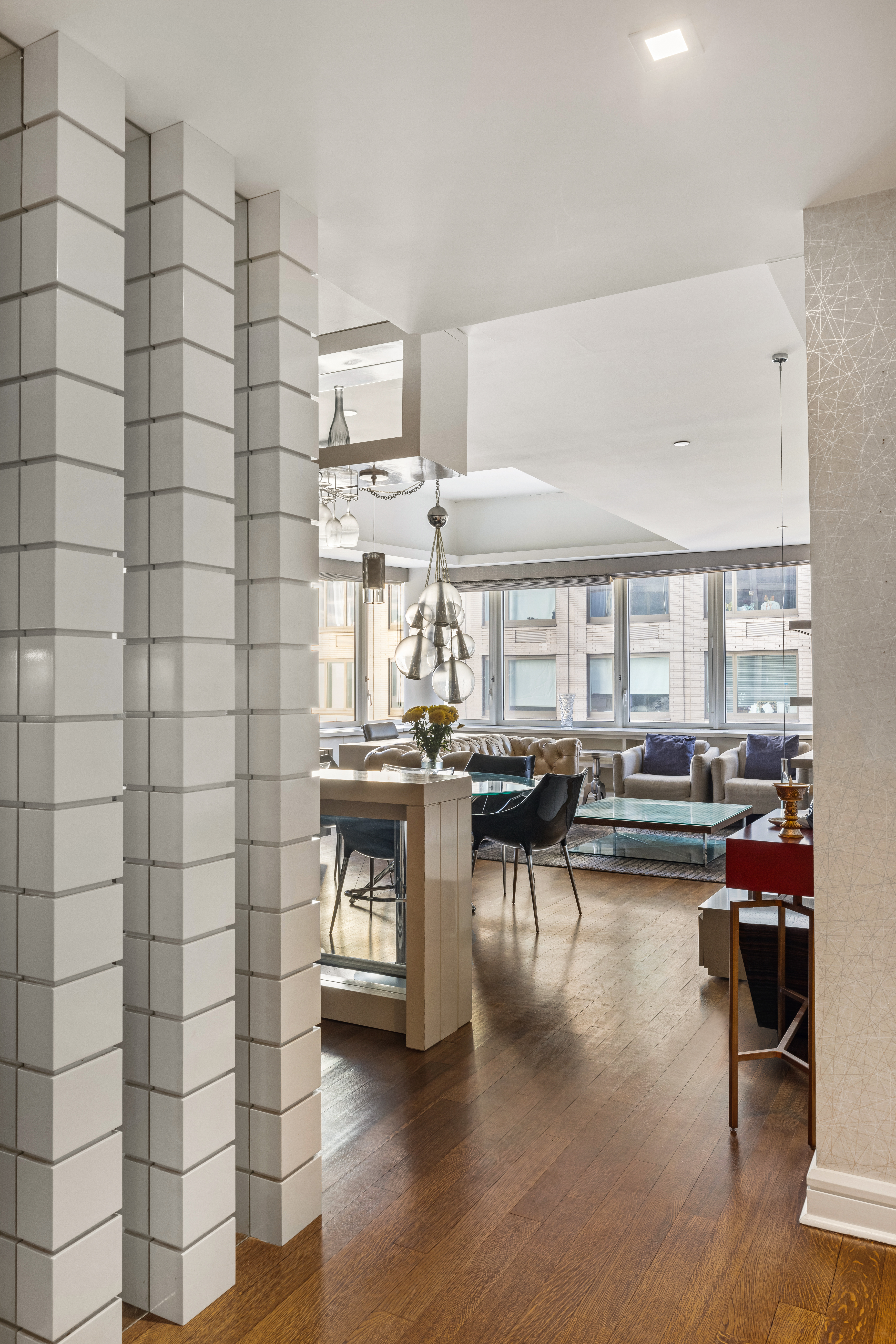 80 Riverside Boulevard, Unit 7E Manhattan, NY 10069 - Photo 11 of 12 a living room with couches and kitchen view with wooden floor
