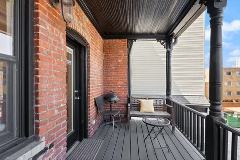 a spacious bedroom with a bed and wooden floor