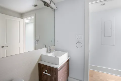 a bathroom with a sink mirror and vanity