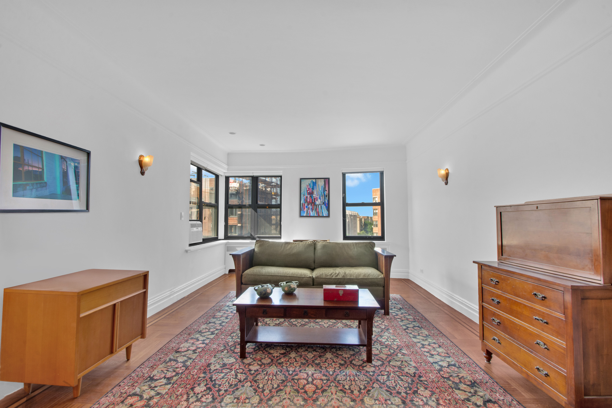 200 Pinehurst Avenue, Unit 5C Manhattan, NY 10033 - Photo 2 of 17 a living room with furniture and a flat screen tv