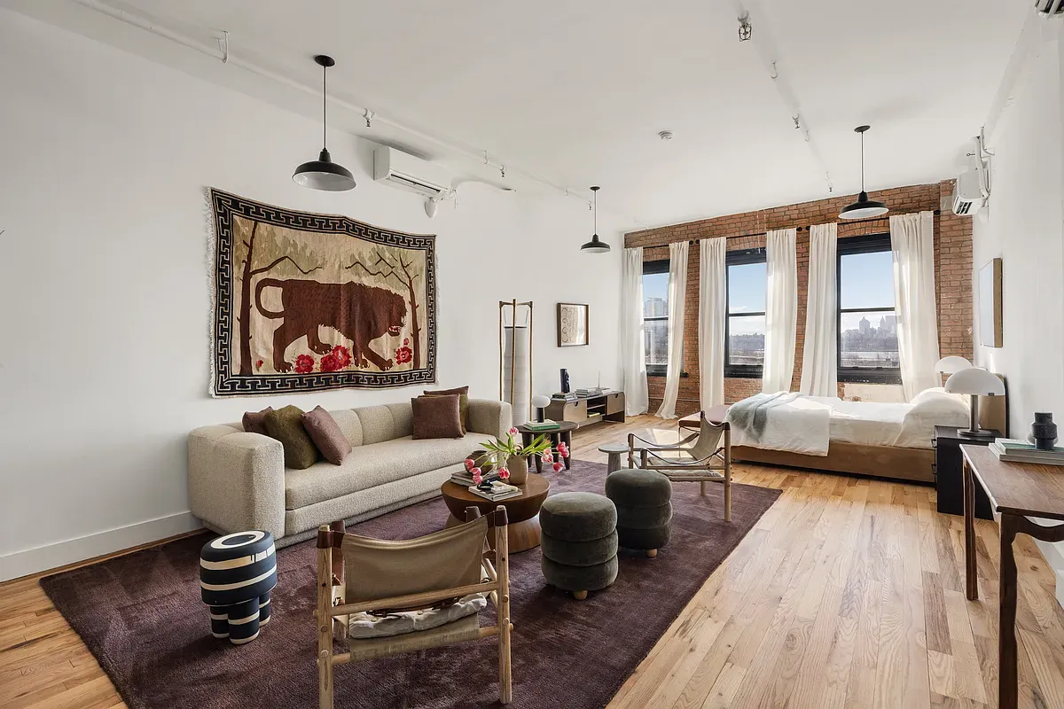 a living room with furniture or couch and a wooden floor