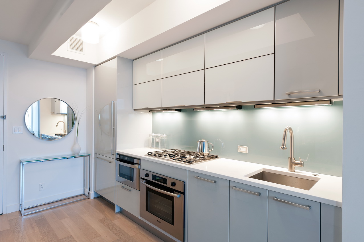22 North 6th Street, Unit 24E Brooklyn, NY 11249 - Photo 3 of 9 a kitchen with a stove cabinets and a wooden floor
