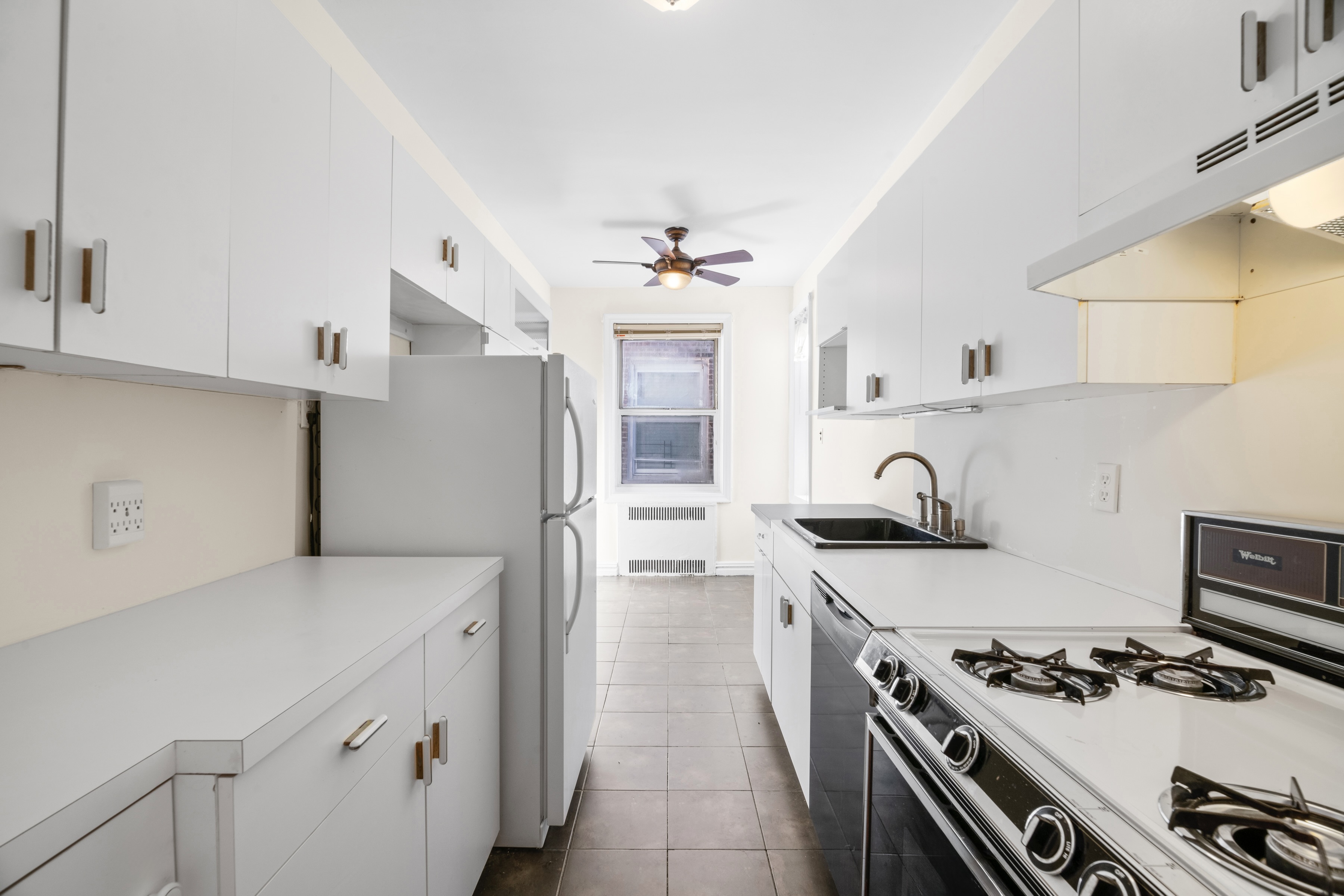 40 Tehama Street, Unit 6E Brooklyn, NY 11218 - Photo 7 of 16 a kitchen with stainless steel appliances granite countertop a sink stove and refrigerator