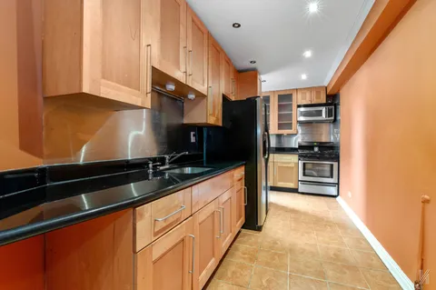 a kitchen with stainless steel appliances granite countertop a stove and a microwave