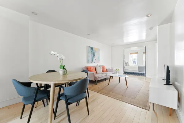 a living room with furniture and wooden floor