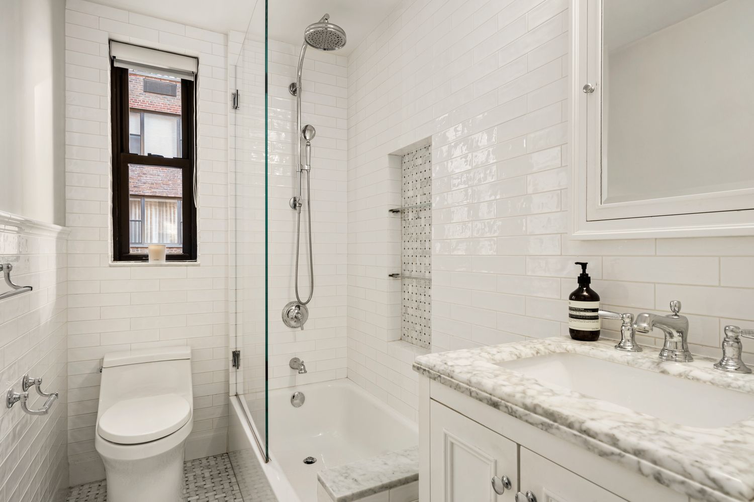 a bathroom with a granite countertop sink toilet and shower