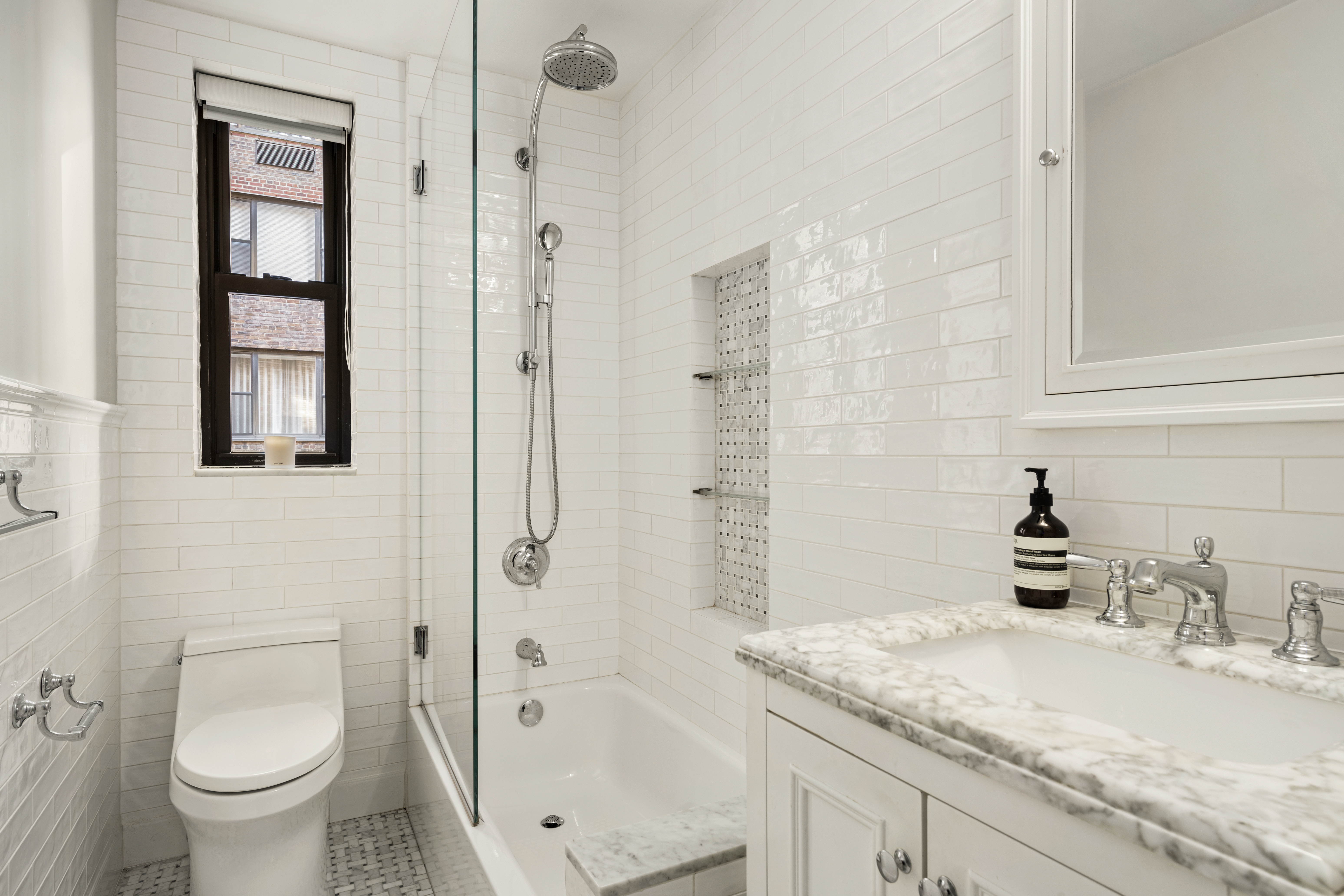 245 East 72nd Street, Unit 6F Manhattan, NY 10021 - Photo 4 of 9 a bathroom with a granite countertop sink toilet and shower
