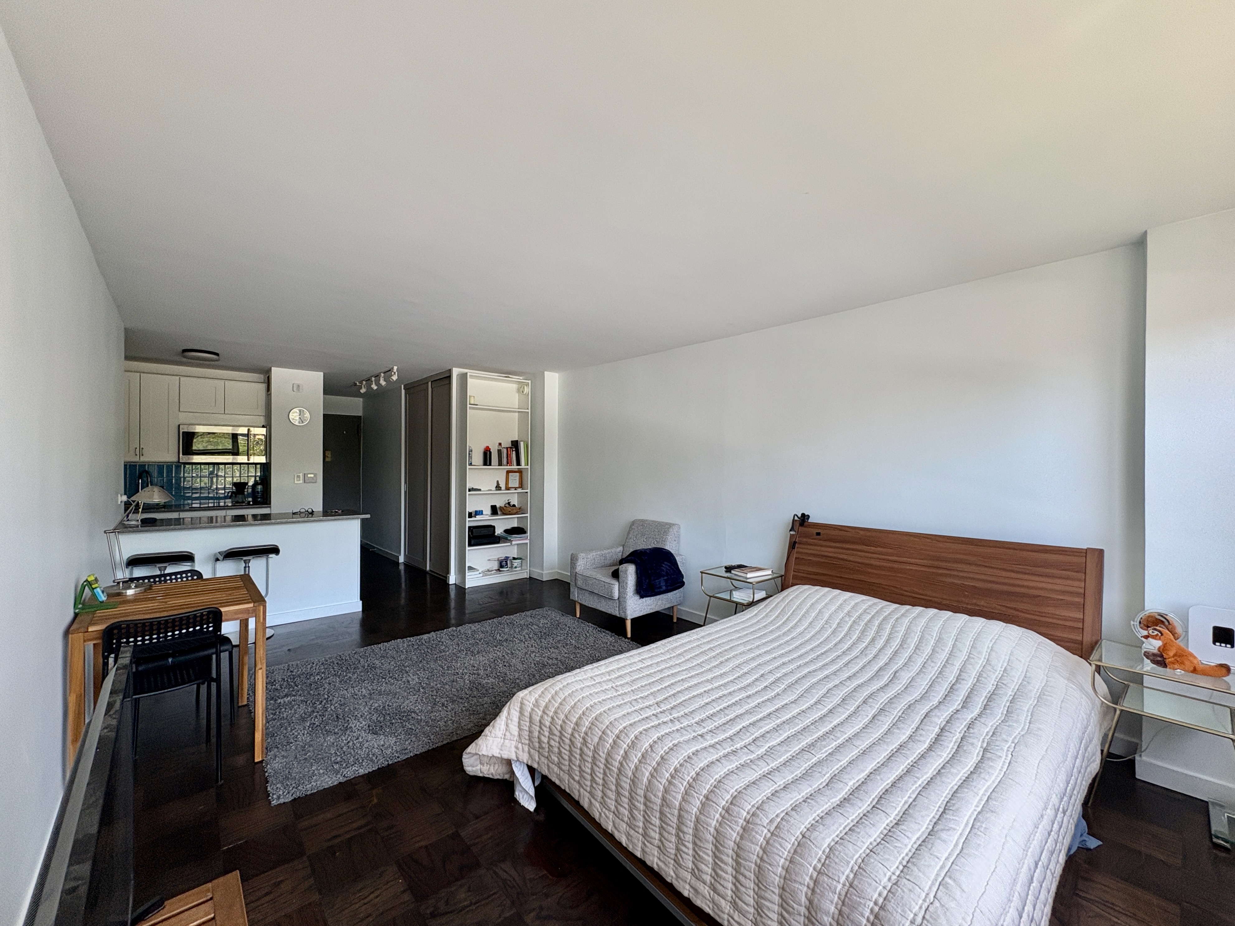 360 West 22nd Street, Unit 7P Manhattan, NY 10011 - Photo 2 of 13 a bedroom with a bed and wooden floor