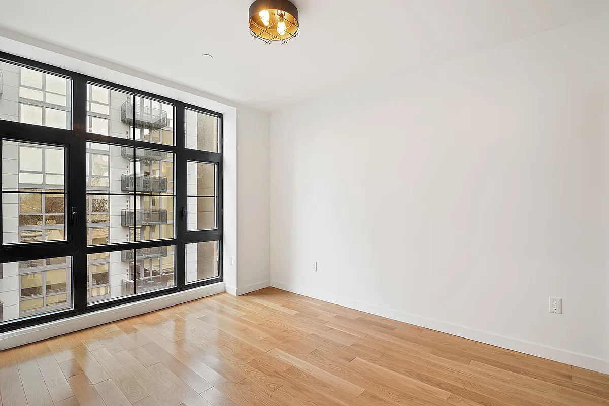 41-21 23rd Street, Unit 6C Queens, NY 11101 - Photo 5 of 10 a view of an empty room with a window
