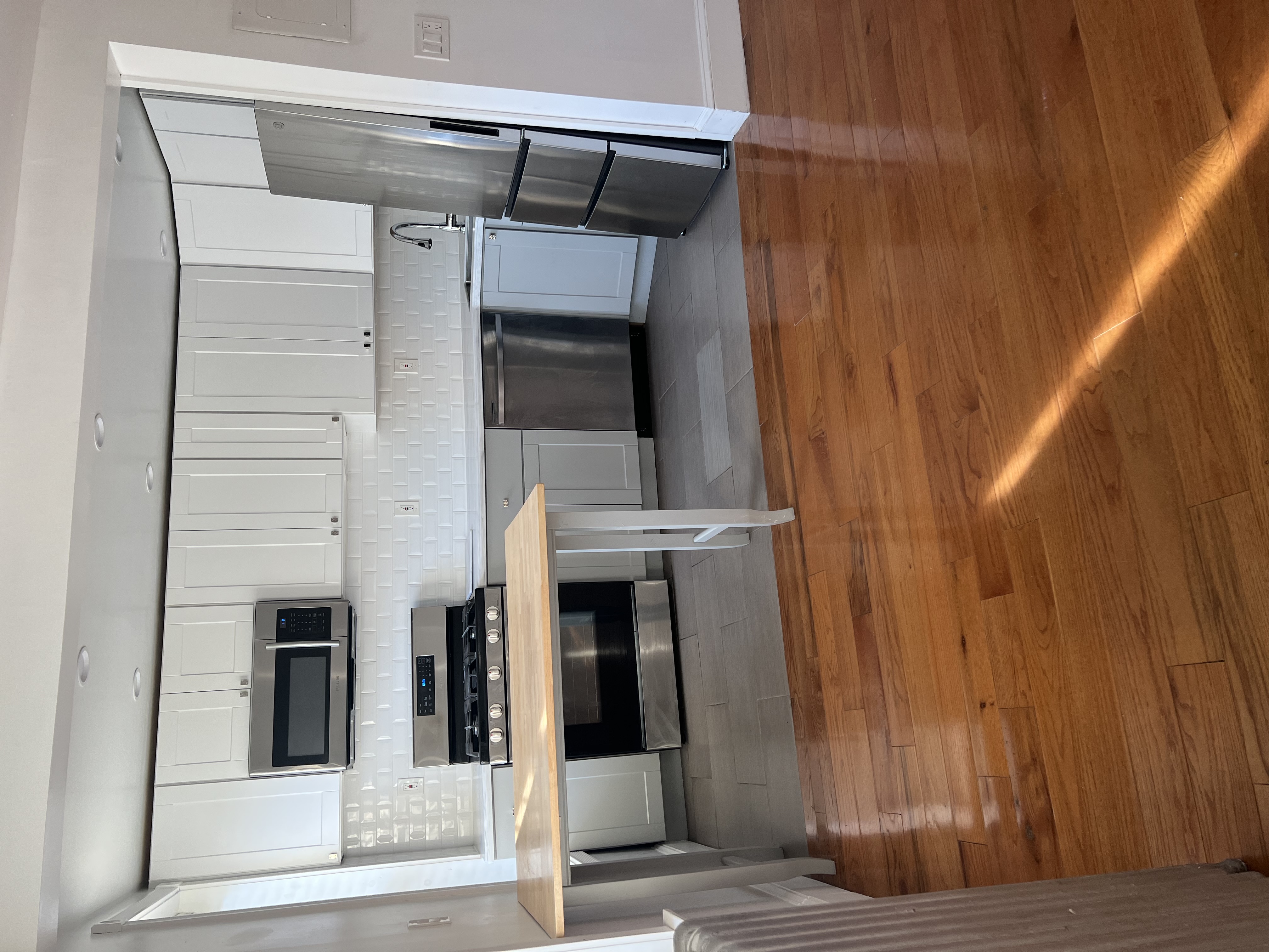 160 Macon Street, Unit 3 Brooklyn, NY 11216 - Photo 4 of 7 a kitchen with stainless steel appliances a stove a refrigerator and a sink