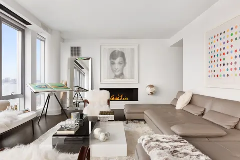 a living room with furniture and fireplace