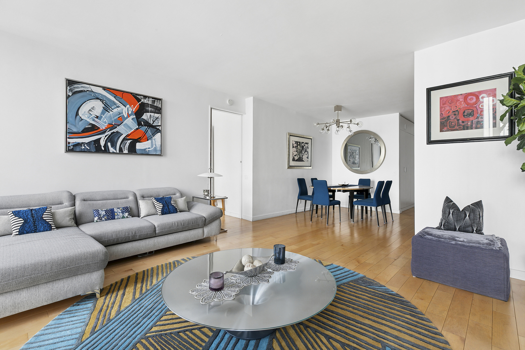 641 5th Avenue, Unit 28B Manhattan, NY 10022 - Photo 3 of 12 a living room with furniture and a wooden floor