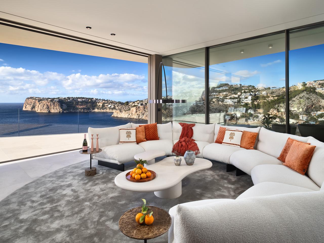 a living room with furniture and a floor to ceiling window
