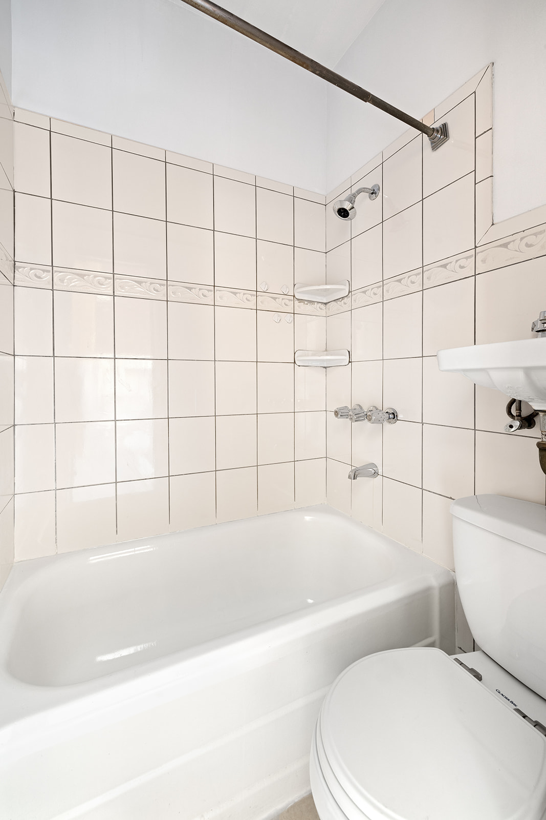 83 Maujer Street, Unit 2R Brooklyn, NY 11206 - Photo 5 of 6 a white bath tub sitting next to a white toilet