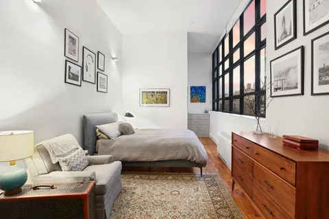 a bedroom with a bed and a desk