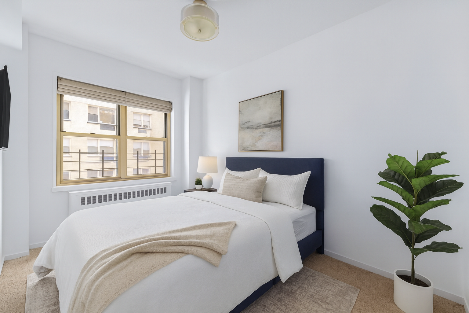 415 East 52nd Street, Unit 9AA Manhattan, NY 10022 - Photo 3 of 10 a bedroom with a bed plant and a window