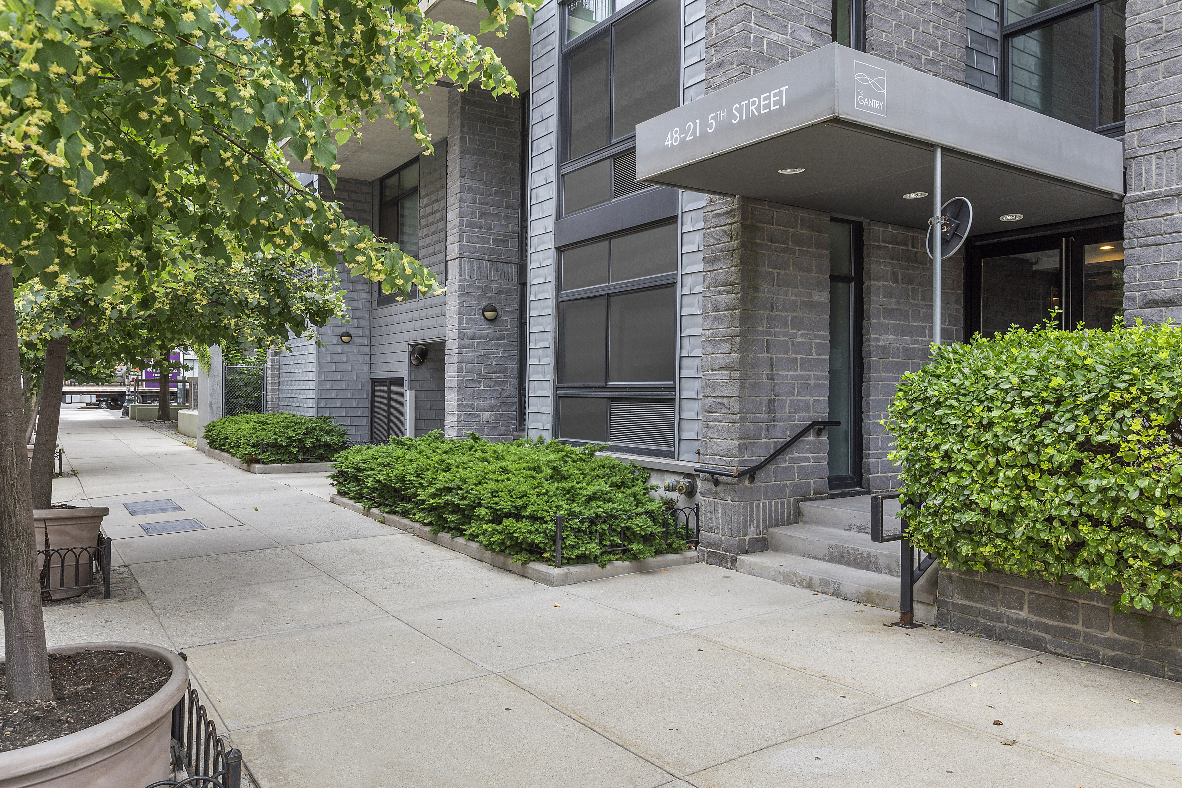48-21 5th Street, Unit 3H Queens, NY 11101 - Photo 9 of 10 a front view of a house with garden
