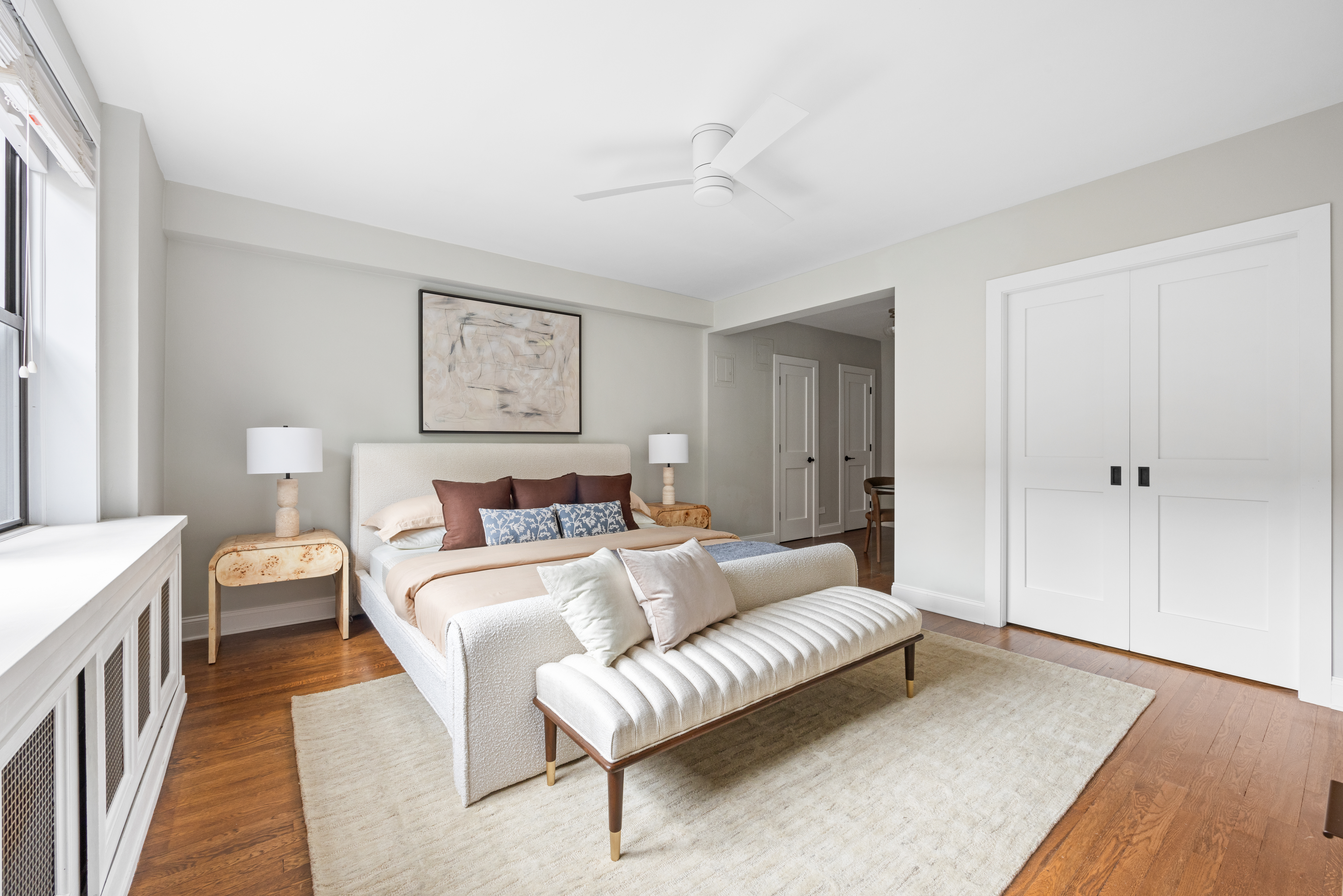 211 East 18th Street, Unit 2O Manhattan, NY 10003 - Photo 7 of 14 a bedroom with a bed and a couch