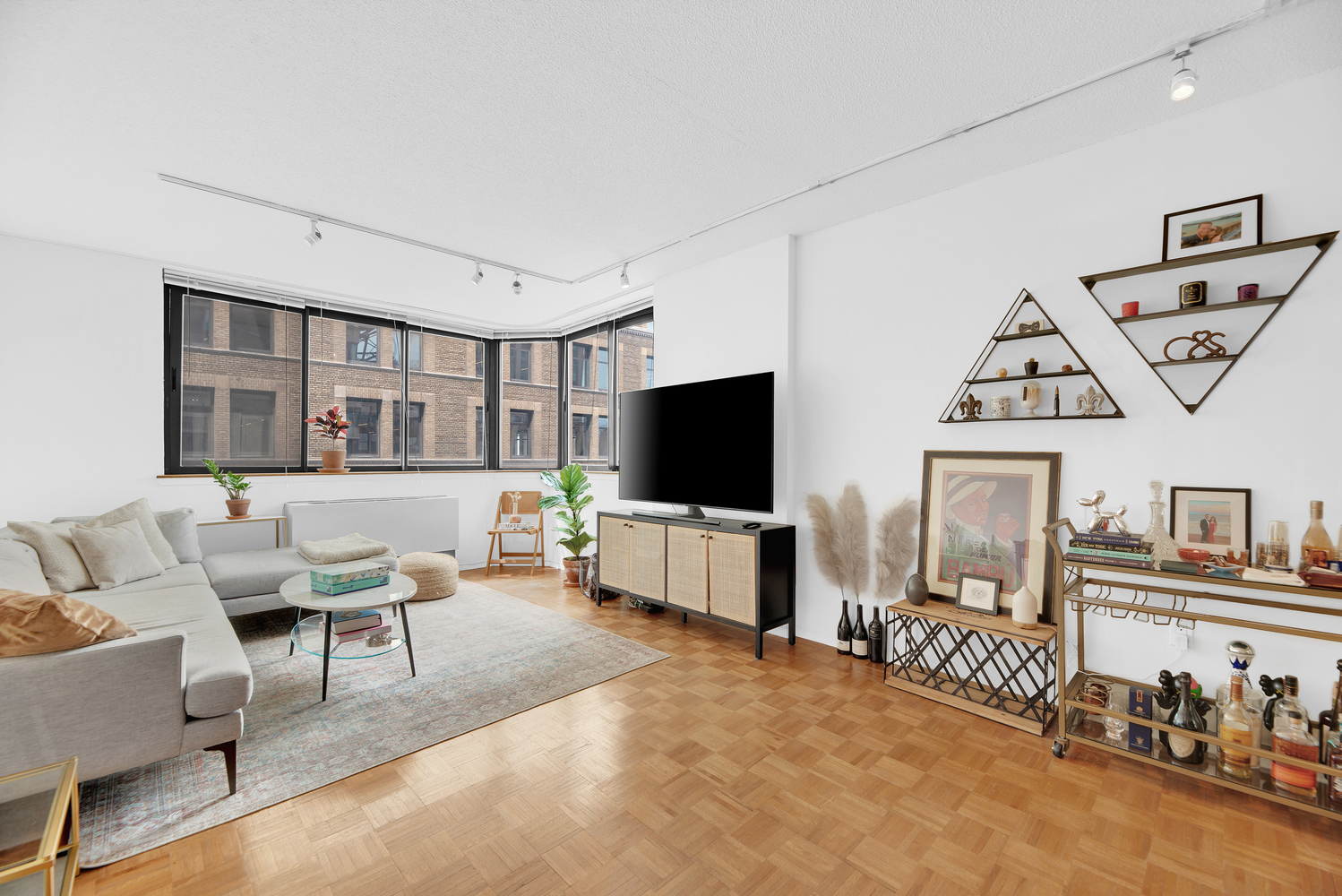280 Park Avenue South, Unit 13M Manhattan, NY 10010 - Photo 1 of 15 a living room with furniture and a flat screen tv