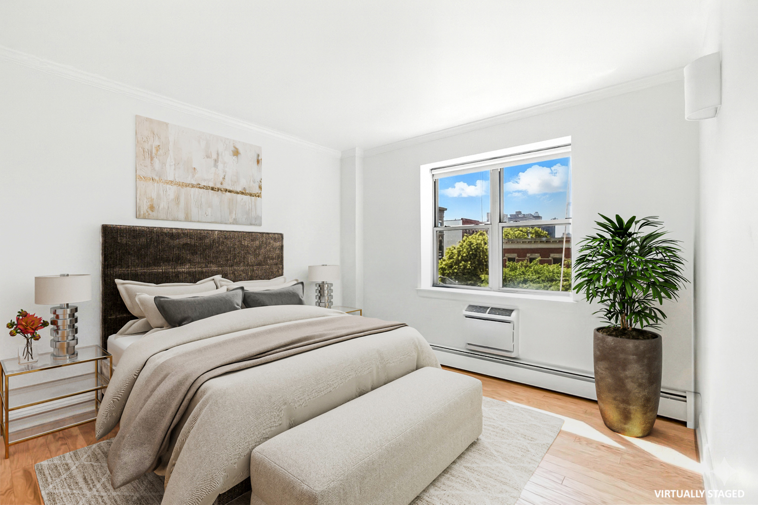 1787 Madison Avenue, Unit 402 Manhattan, NY 10035 - Photo 3 of 13 a bedroom with a large bed and a potted plant