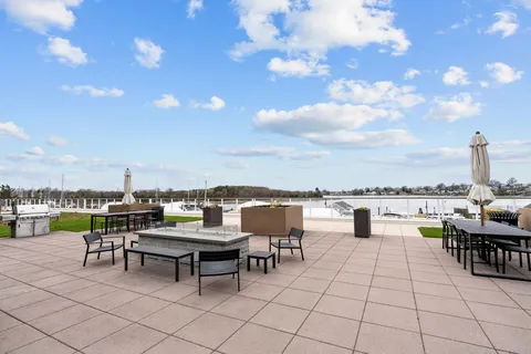 a view of a terrace with furniture and a garden