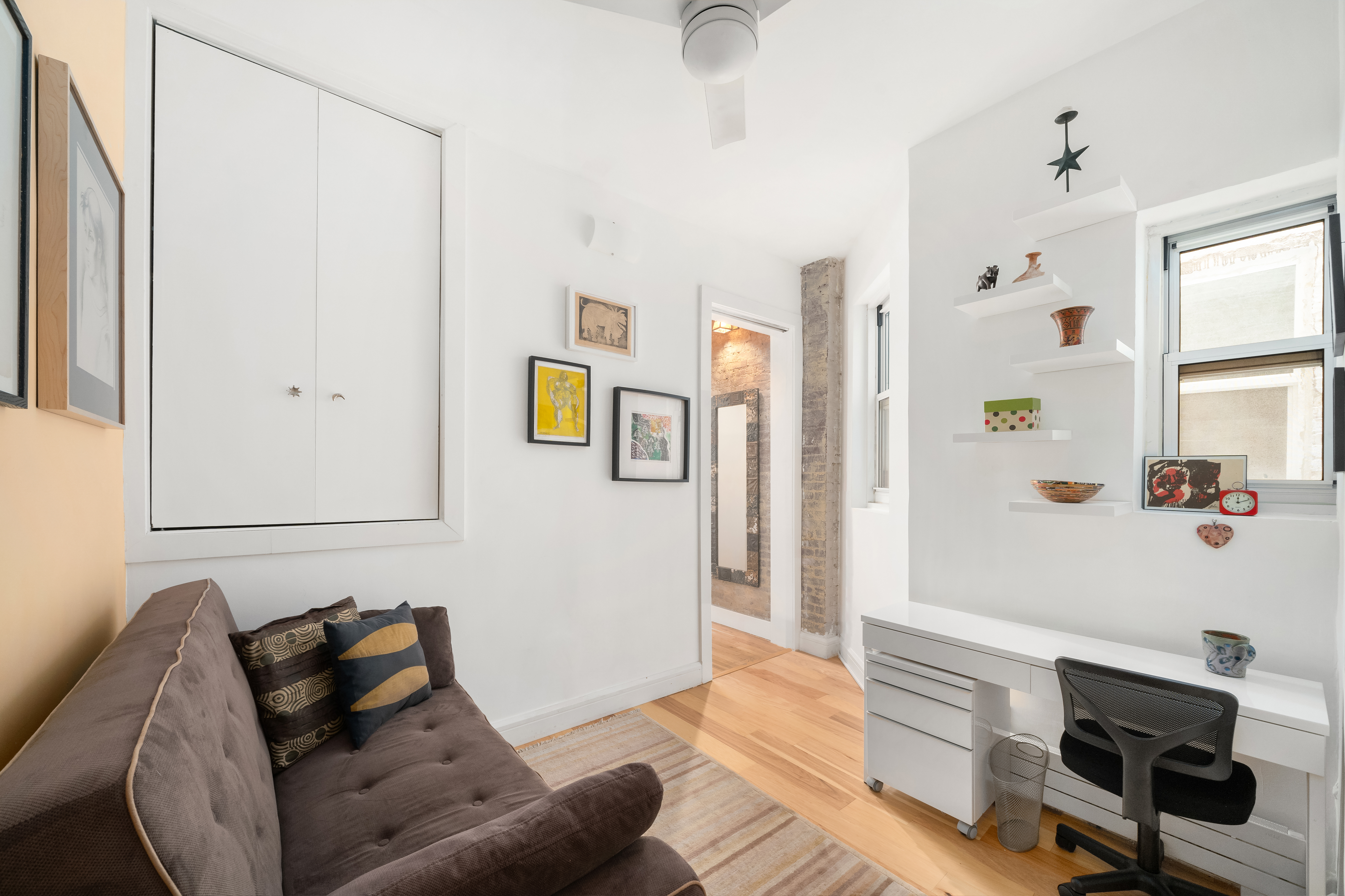 92 Horatio Street, Unit 1J Manhattan, NY 10014 - Photo 9 of 16 a living room with furniture and a window