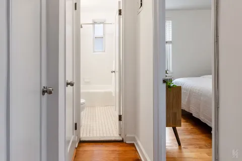 a view of a bathroom with a tub and shower
