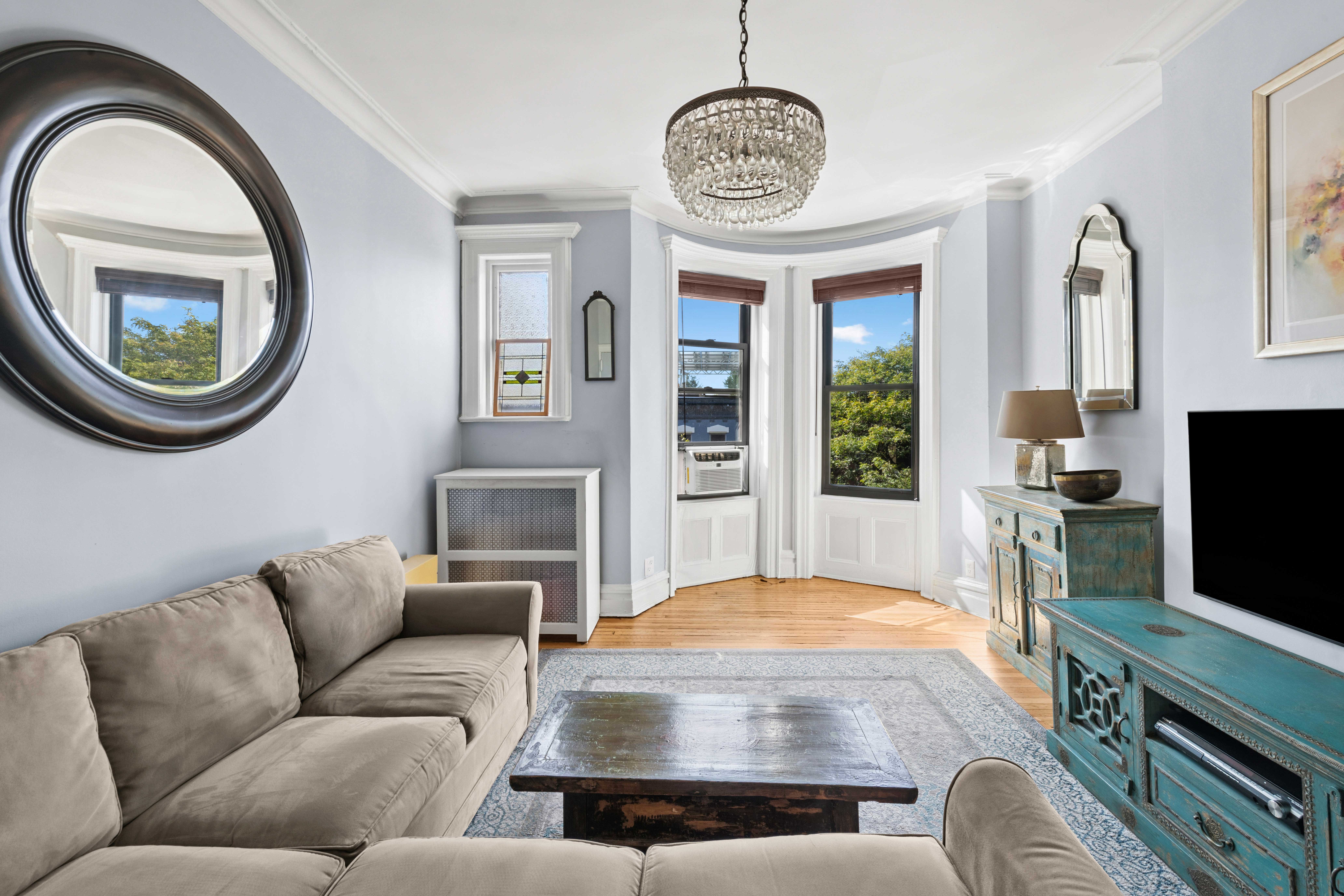 705 Carroll Street, Unit 4L Brooklyn, NY 11215 - Photo 5 of 15 a living room with furniture a flat screen tv and a fireplace
